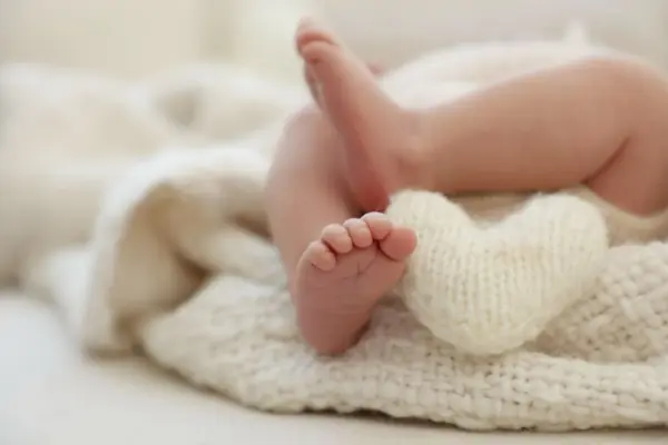 Newborn photography Monsey NY – Close-up of a newborn's tiny feet on a soft blanket